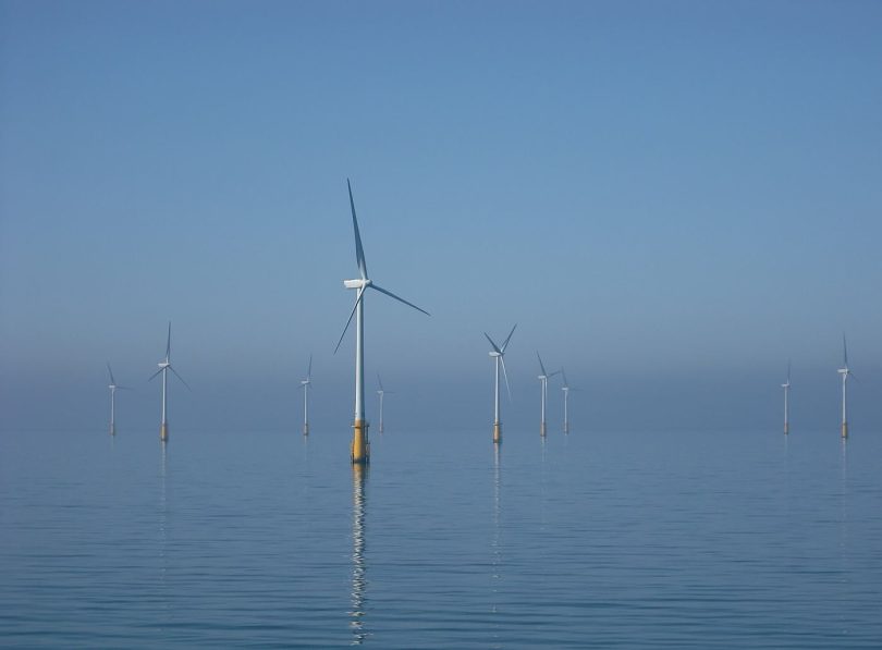 Offshore wind turbines standing in the sea near the coast